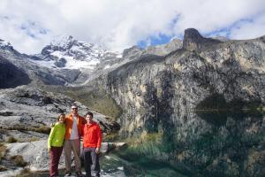 (L to R) Ana, Ben, and David at Laguna Churup, with the southwest face of Churup Oeste (5493m) towering above the valley.